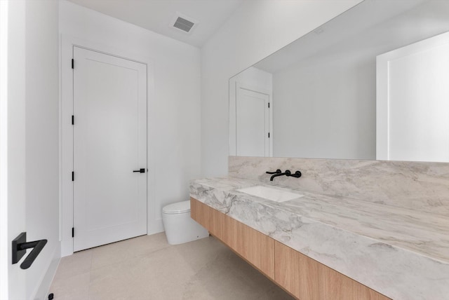 880 NE 3rd Ave, Boca Raton, FL 33432 - bathroom featuring vanity, toilet, and tile patterned flooring