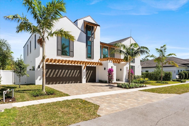 880 NE 3rd Ave, Boca Raton, FL 33432 - view of front of house with stucco siding, an attached garage, and decorative driveway