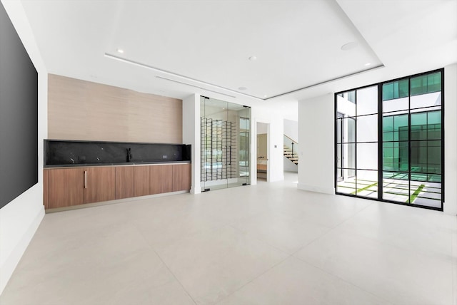 880 NE 3rd Ave, Boca Raton, FL 33432 - empty room featuring a tray ceiling, stairway, and recessed lighting