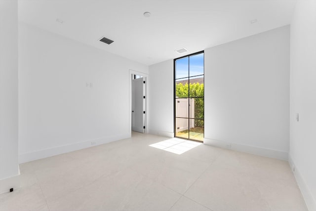 880 NE 3rd Ave, Boca Raton, FL 33432 - tiled spare room with expansive windows and baseboards