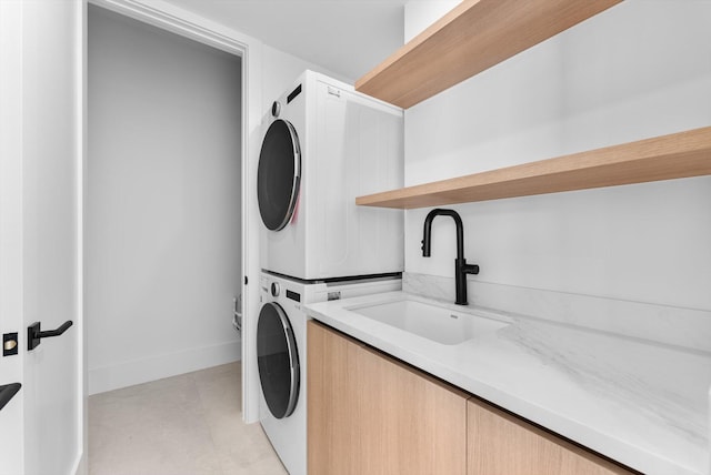 880 NE 3rd Ave, Boca Raton, FL 33432 - laundry area with stacked washing machine and dryer and baseboards