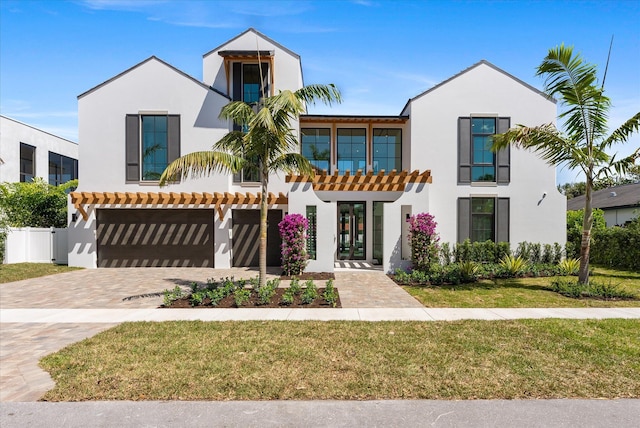 880 NE 3rd Ave, Boca Raton, FL 33432 - view of front of home featuring stucco siding, decorative driveway, and an attached garage