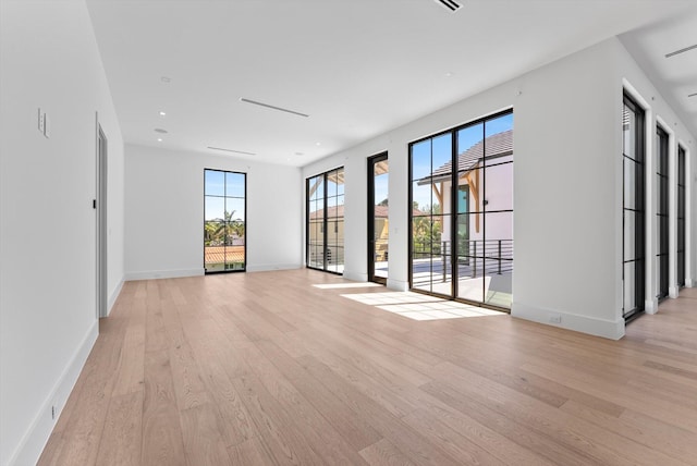 880 NE 3rd Ave, Boca Raton, FL 33432 - empty room featuring light wood-style floors, plenty of natural light, baseboards, and recessed lighting