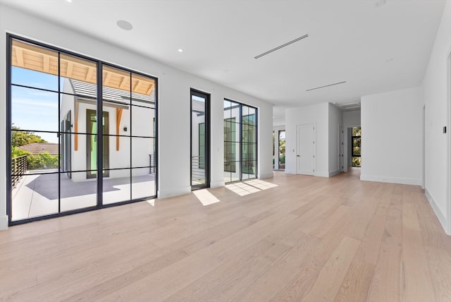 880 NE 3rd Ave, Boca Raton, FL 33432 - unfurnished living room featuring light wood-style flooring and baseboards