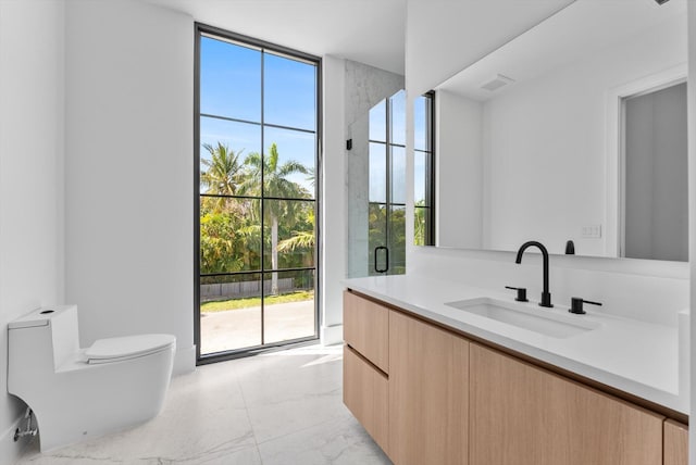 880 NE 3rd Ave, Boca Raton, FL 33432 - full bathroom featuring plenty of natural light, marble finish flooring, expansive windows, toilet, and vanity