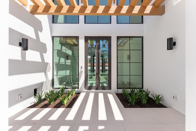 880 NE 3rd Ave, Boca Raton, FL 33432 - view of exterior entry with stucco siding and french doors