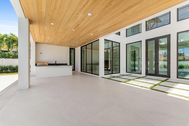 880 NE 3rd Ave, Boca Raton, FL 33432 - view of patio with an outdoor kitchen and fence
