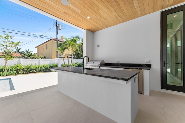 880 NE 3rd Ave, Boca Raton, FL 33432 - view of patio featuring exterior kitchen, fence, and a sink