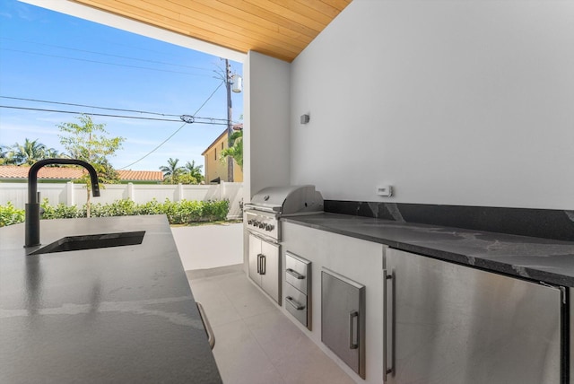 880 NE 3rd Ave, Boca Raton, FL 33432 - view of patio featuring grilling area, a sink, fence, and an outdoor kitchen