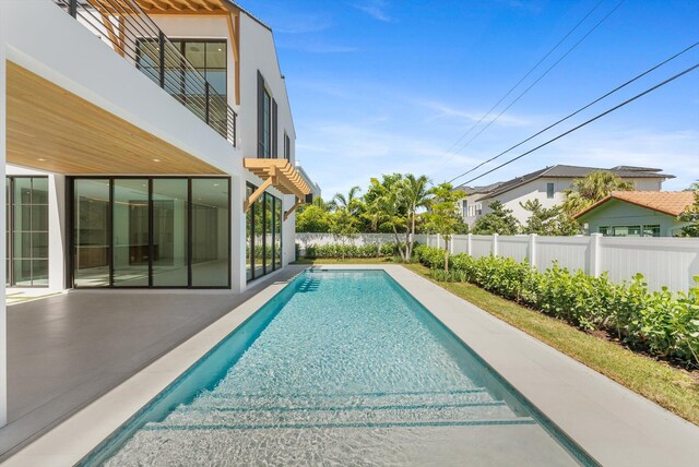 880 NE 3rd Ave, Boca Raton, FL 33432 - view of pool featuring a fenced backyard and a patio