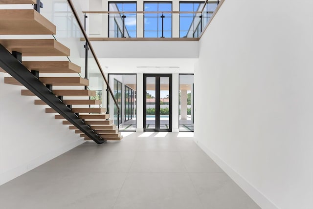 880 NE 3rd Ave, Boca Raton, FL 33432 - tiled foyer entrance featuring french doors, baseboards, stairway, and a high ceiling