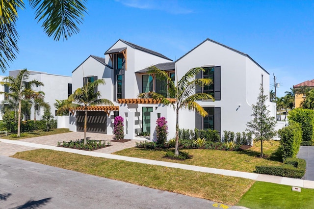 880 NE 3rd Ave, Boca Raton, FL 33432 - view of front of home with stucco siding, decorative driveway, and a front yard