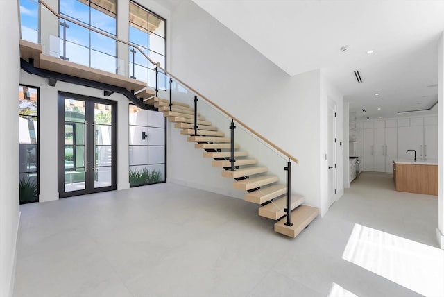 880 NE 3rd Ave, Boca Raton, FL 33432 - entryway featuring stairs, french doors, and a towering ceiling
