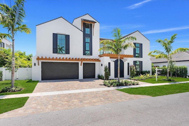880 NE 3rd Ave, Boca Raton, FL 33432 - view of front of house featuring stucco siding, a garage, decorative driveway, and french doors