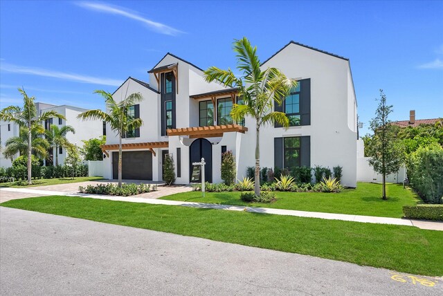 880 NE 3rd Ave, Boca Raton, FL 33432 - view of front of house featuring stucco siding, a garage, a front yard, and driveway