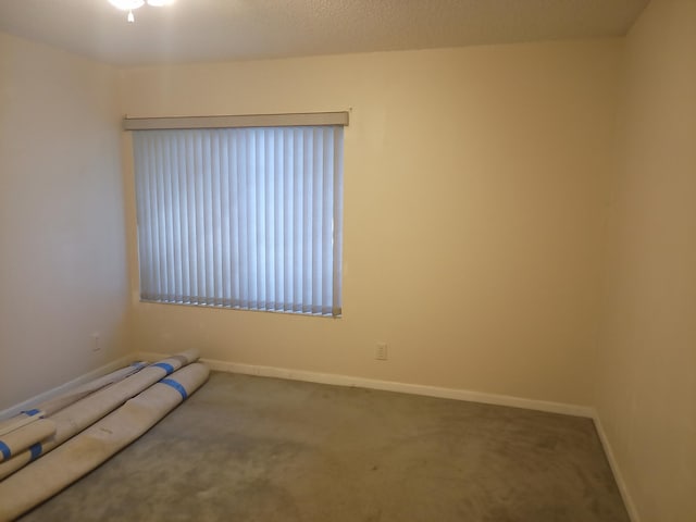 2231 NW 34th Ter, Coconut Creek, FL 33066 - spare room featuring a textured ceiling, baseboards, and carpet floors