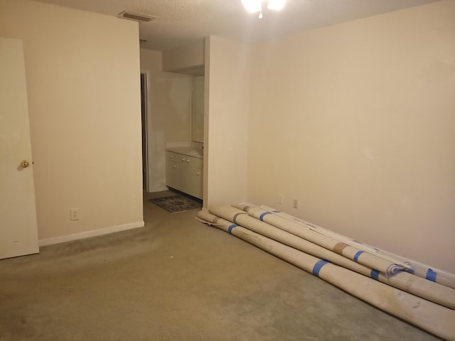 2231 NW 34th Ter, Coconut Creek, FL 33066 - unfurnished bedroom featuring visible vents, baseboards, carpet floors, ensuite bath, and a textured ceiling