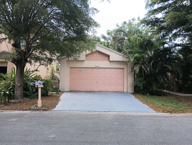 2231 NW 34th Ter, Coconut Creek, FL 33066 - view of front of property featuring concrete driveway, a garage, and stucco siding