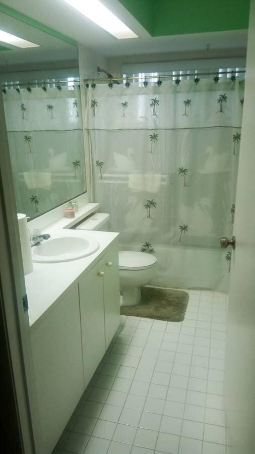 2231 NW 34th Ter, Coconut Creek, FL 33066 - full bath with tile patterned flooring, toilet, vanity, and shower / bathtub combination with curtain