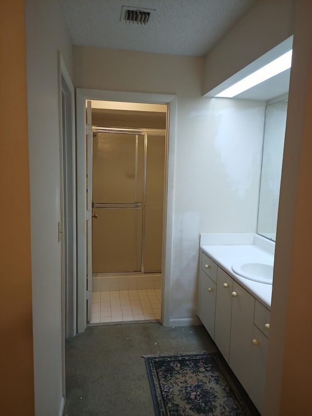 2231 NW 34th Ter, Coconut Creek, FL 33066 - bathroom with visible vents, a textured ceiling, a stall shower, and vanity
