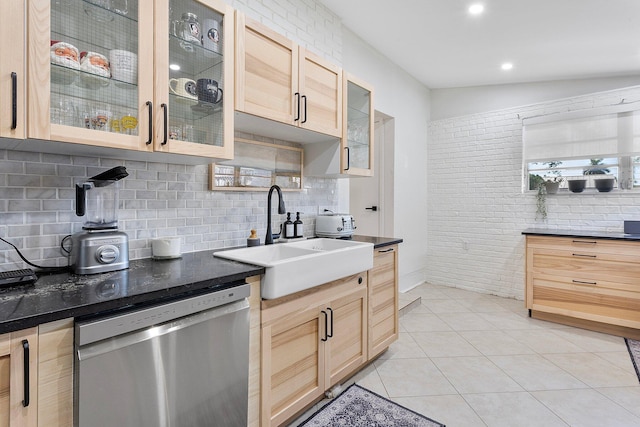 5400 NE 1st Ter, Oakland Park, FL 33334 - kitchen featuring dark countertops, light brown cabinets, stainless steel dishwasher, light tile patterned flooring, and a sink