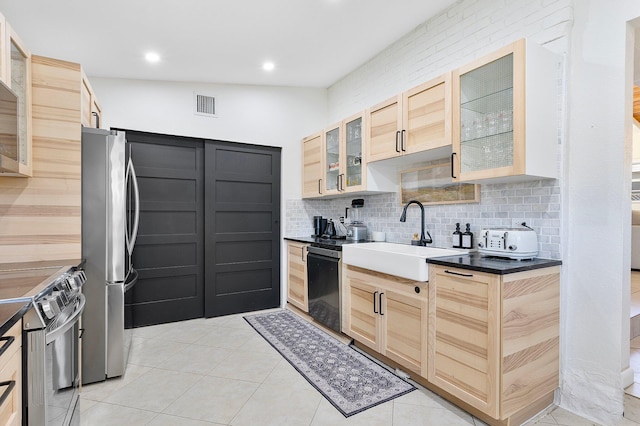 5400 NE 1st Ter, Oakland Park, FL 33334 - kitchen with visible vents, range with electric cooktop, a sink, freestanding refrigerator, and dishwashing machine