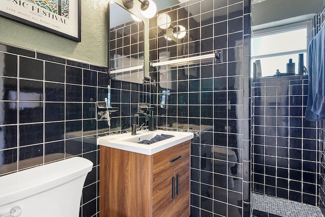5400 NE 1st Ter, Oakland Park, FL 33334 - bathroom with vanity, tiled shower, tile walls, toilet, and a textured wall