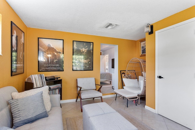5400 NE 1st Ter, Oakland Park, FL 33334 - living area with tile patterned floors, visible vents, baseboards, and a textured ceiling