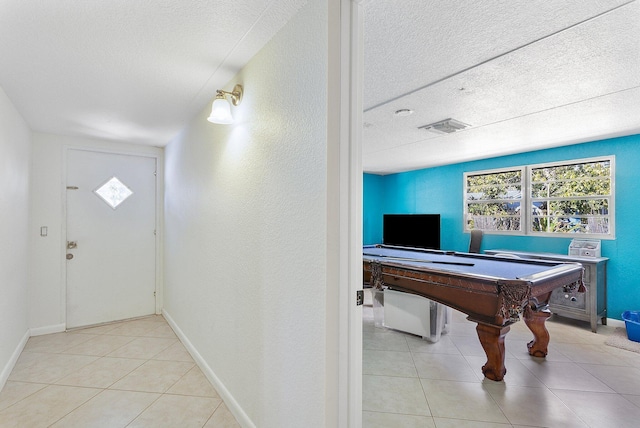 5400 NE 1st Ter, Oakland Park, FL 33334 - tiled entryway featuring billiards, baseboards, visible vents, and a textured ceiling