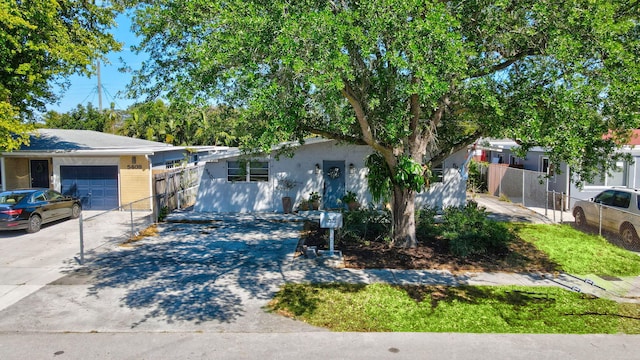 5400 NE 1st Ter, Oakland Park, FL 33334 - view of front of property with a garage, concrete driveway, and fence