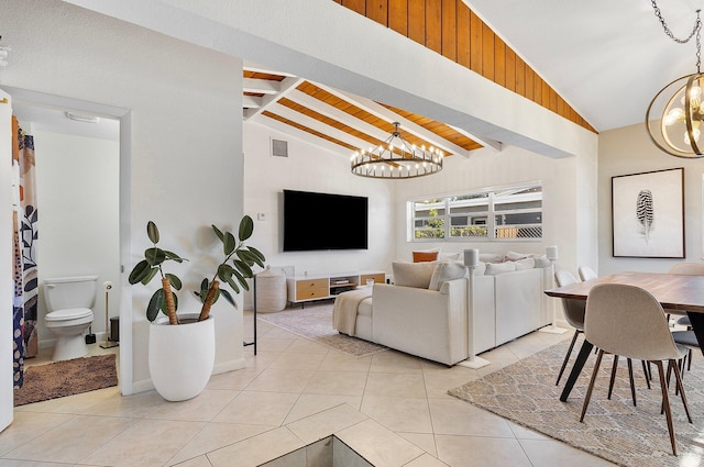 5400 NE 1st Ter, Oakland Park, FL 33334 - living room featuring visible vents, vaulted ceiling with beams, wood ceiling, light tile patterned floors, and a notable chandelier