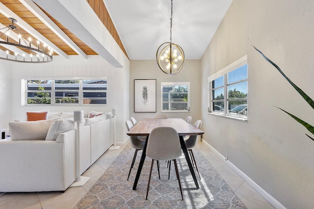 5400 NE 1st Ter, Oakland Park, FL 33334 - dining space with beam ceiling, light tile patterned flooring, baseboards, and a chandelier