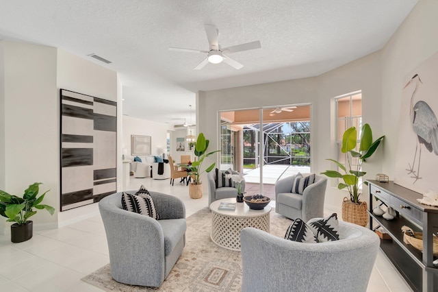 2680 Hancock Creek Rd, West Palm Beach, FL 33411 - living area featuring ceiling fan, light tile patterned floors, a textured ceiling, a sunroom, and baseboards