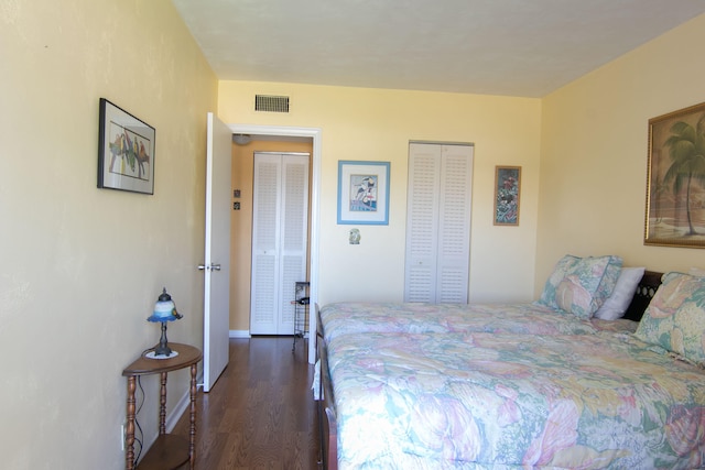 bedroom with dark wood finished floors and visible vents