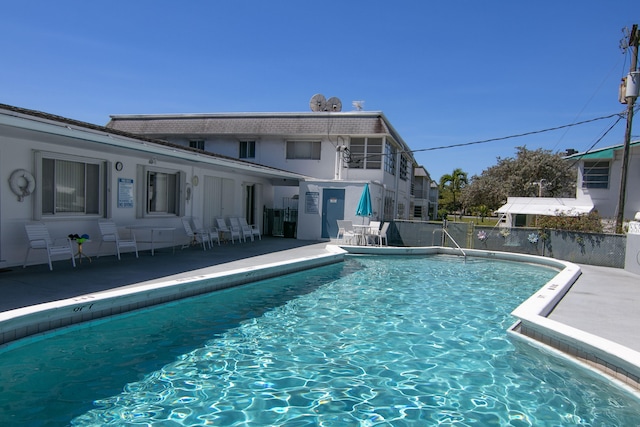 community pool featuring fence and a patio area