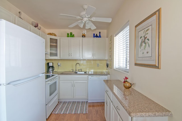 kitchen featuring decorative backsplash, white appliances, a ceiling fan, white cabinetry, and a sink