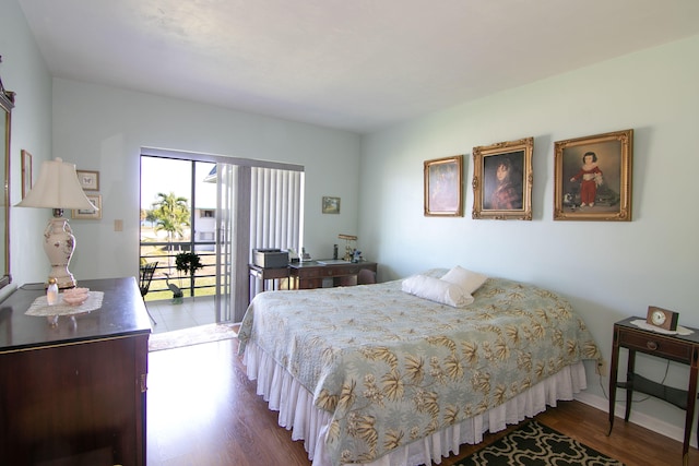 bedroom featuring baseboards, access to exterior, and wood finished floors
