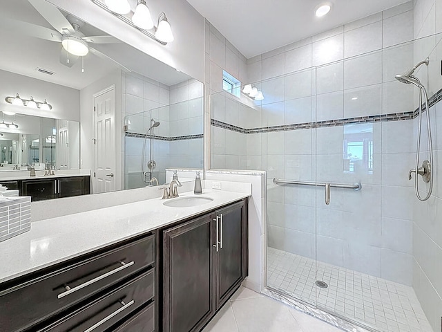 full bath with visible vents, a ceiling fan, a shower stall, tile patterned flooring, and vanity