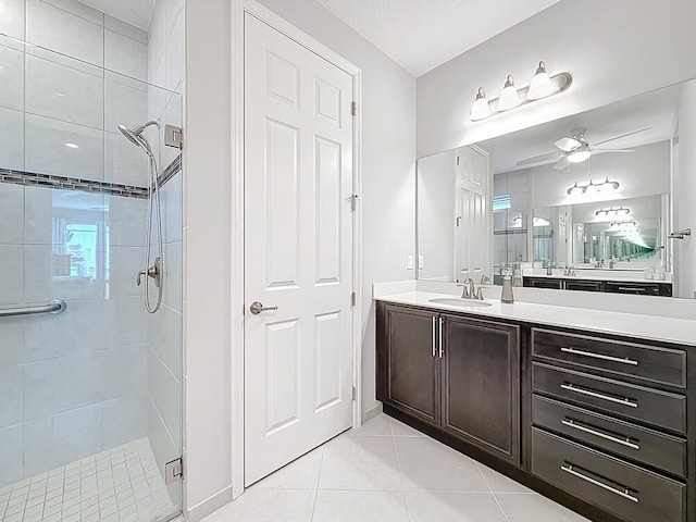 bathroom featuring vanity, baseboards, a stall shower, ceiling fan, and tile patterned flooring