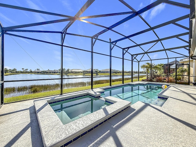 view of pool with glass enclosure, a patio, a water view, and a pool with connected hot tub