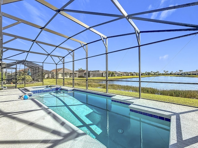 view of swimming pool with a water view, a patio, a lanai, and a pool with connected hot tub
