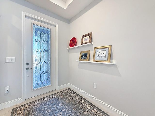 foyer entrance featuring baseboards and tile patterned flooring