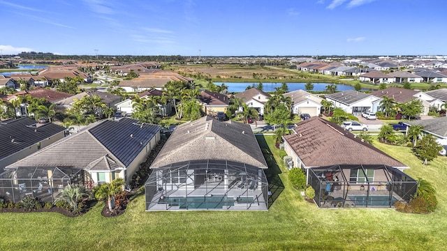 drone / aerial view with a residential view and a water view
