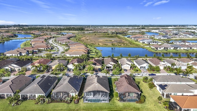 drone / aerial view with a residential view and a water view