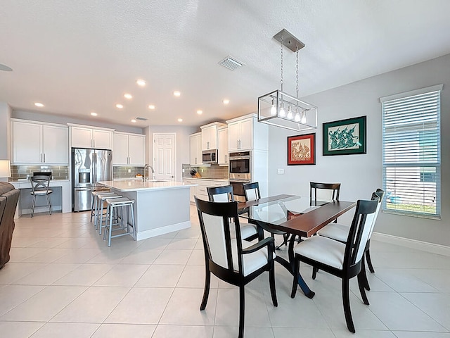 dining space with light tile patterned floors, visible vents, baseboards, and recessed lighting