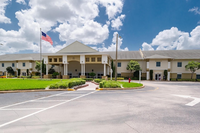 view of building exterior featuring uncovered parking