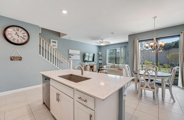 1012 Willow Pl, Riviera Beach, FL 33410 - kitchen with a sink, stainless steel dishwasher, decorative light fixtures, a chandelier, and light stone counters