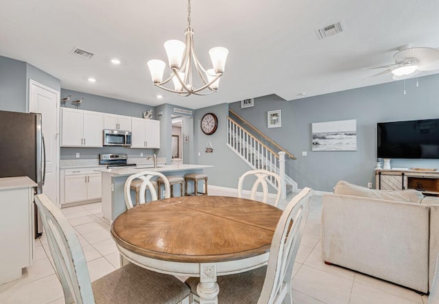 1012 Willow Pl, Riviera Beach, FL 33410 - dining room featuring light tile patterned floors, a ceiling fan, a chandelier, recessed lighting, and stairway