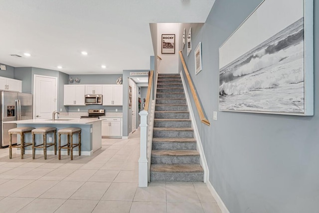 1012 Willow Pl, Riviera Beach, FL 33410 - staircase featuring tile patterned floors, recessed lighting, and baseboards