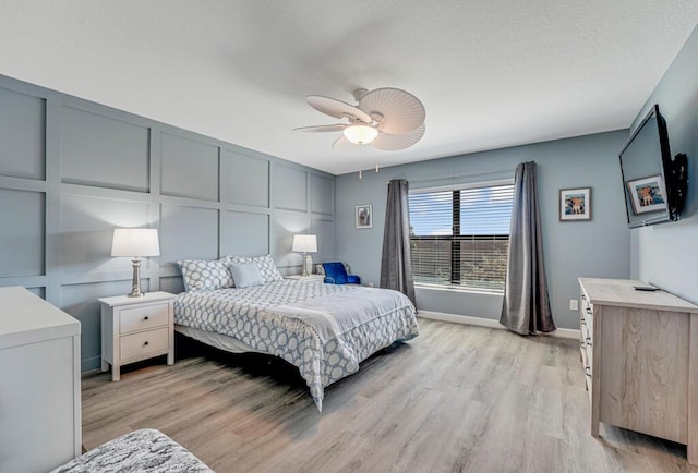 1012 Willow Pl, Riviera Beach, FL 33410 - bedroom featuring light wood-style floors, a decorative wall, baseboards, and a ceiling fan